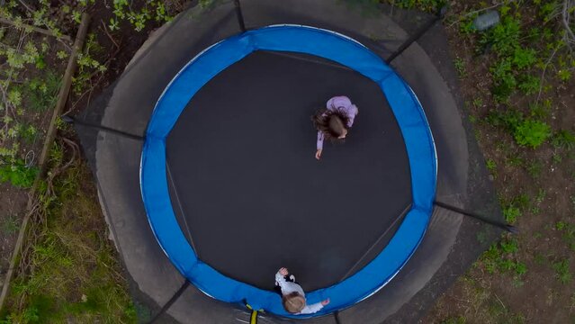 Drone view of jumping girls from above.