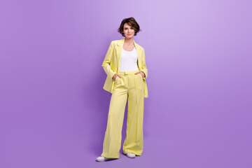 Full length photo of cheerful adorable lady wear suit blazer smiling walking isolated violet color...