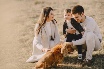 Stylish family walking on a spring field