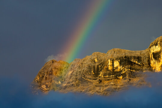 Superb rainbow on cross mountain Monte croce Dolomites Alps near Alta Badia, Trentino-Alto-Adige region, Italy. Summer season.