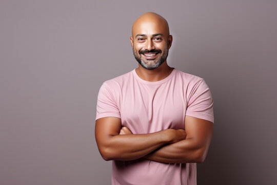 indian bald man standing isolated against plain background