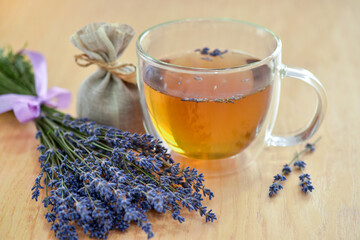 Fresh delicious tea with lavender and lavender flowers on a wooden table