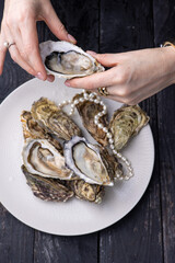 large, beautiful, fresh oysters on a dark table. Close up
