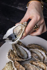 large, beautiful, fresh oysters on a dark table. Close up
