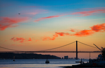 Beautiful summer sunset over The Tagus river in Lisbon, Portugal. Selective focus.