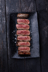 Delicious marbled meat on a dark background. Close up