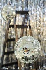 A large mirror ball on a shiny background. Reflective surface to create a lighting effect.