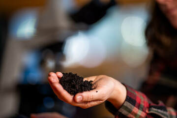 young Female soil scientist holding a soil in a hand in a soil laboratory in australia