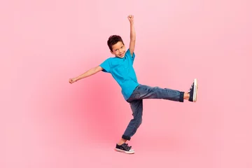 Foto op Plexiglas Dansschool Full length photo of pretty excited little boy dressed blue t-shirt walking dancing isolated pink color background