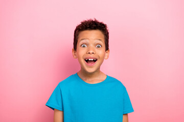 Photo portrait of charming small boy astonished excited win lottery wear trendy blue garment isolated on pink color background