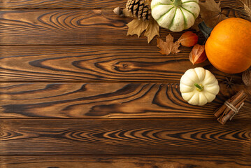 Captivating top view of autumn harvest treasures. Ripe pumpkins and fall attributes arranged on a...