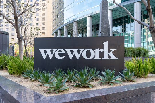 Close up of the WEWORK sign outside an office building at Broadway, Oakland,  California, United States - June 5, 2023. WeWork Inc. is a provider of coworking spaces. 