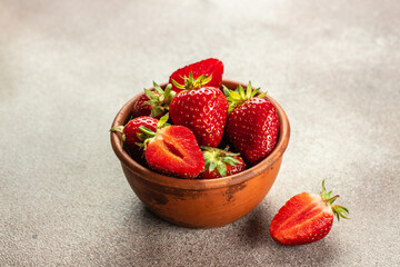 Fresh organic red berry strawberry in bowl on stone table. top view