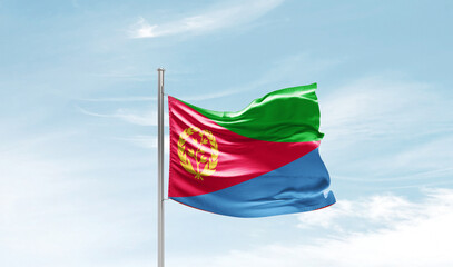 Eritrea national flag waving in beautiful sky. The symbol of the state on wavy silk fabric.