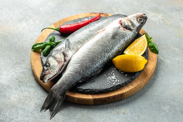 Fresh raw seabass and ingredients for cooking. banner, menu, recipe place for text, top view