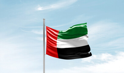 United Arab Emirates national flag waving in beautiful sky. The symbol of the state on wavy silk fabric. - obrazy, fototapety, plakaty