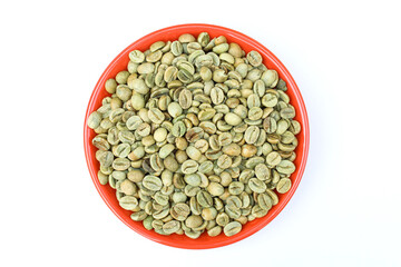 Green coffee beans in a plate on white background top view 