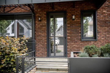 entrance of city cottage, brick walls, glass doors, contemporary design
