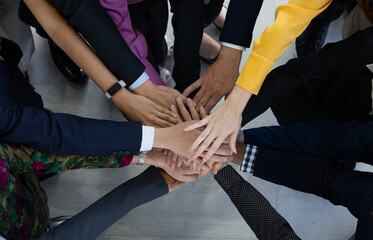 Team, teamwork, and unity concept. Diverse team putting hands together. Group of diverse business...