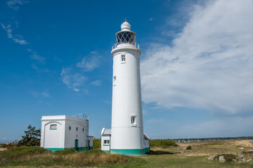 Fototapeta na wymiar Hurst Point Lighthouse is located at Hurst Point in the English county of Hampshire, and guides vessels through the western approaches to the Solent