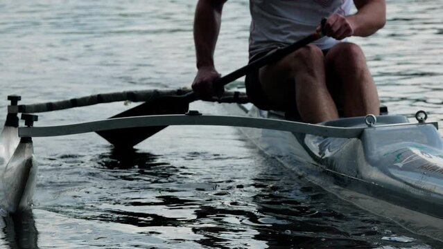  Canoeing competition training coaching workout a outrigger canoe boat sport. Single rowing of men in large water