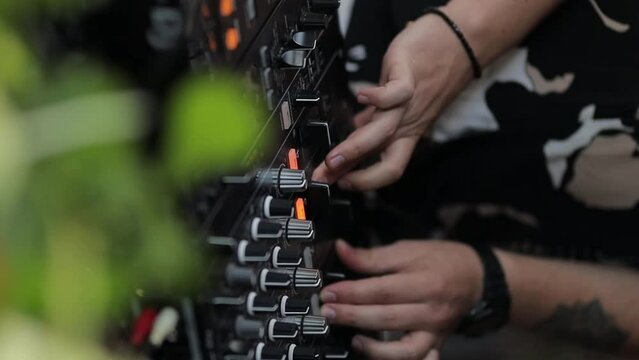 Dj plays beats on drum machine. Disc jockey playing on concert stage with professional midi controller device. Beat machine device for electronic music composer. Vertical orientation video