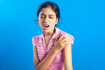 Indian girl struggling with shoulder pain