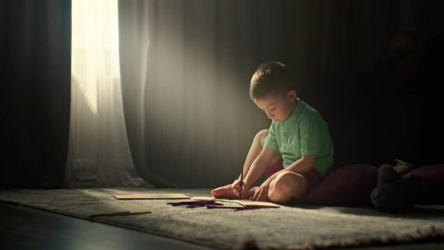 Nurturing Creativity in Kids: Enchanting Scene of a Young Boy Immersed in Pencil Drawing, Embracing the Joy of Artistry at Home. High quality 4k footage