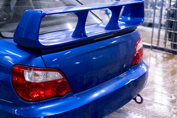 dirty blue car body at car wash