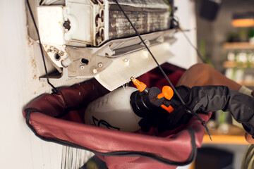  Cleaning the air conditioner by spraying. man washes off a special foam for cleaning air...