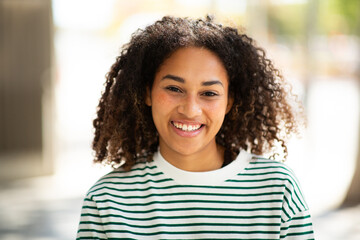 smiling beautiful young woman with curly hair