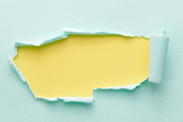 Frame of ripped paper with torn edges. Window for text with copy space yellow blue colors, shreds of notebook pages. Abstract background.