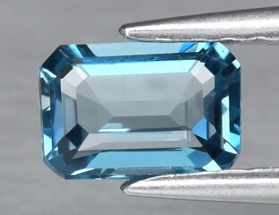 Natural gemstone blue topaz on a gray background