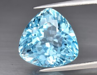 Natural gemstone blue topaz on a gray background