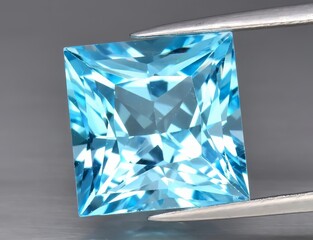 Natural gemstone blue topaz on a gray background