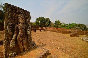 Fototapeta premium Excavated remains depicting Hand sculpted stone figurine of male deity at Udayagiri Buddhist Excavation Site, Odisha, India.