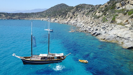 Boat, sailing in Greece and sun on ocean holiday, relax in freedom and nature with clean blue water. Yacht vacation, travel in summer and tropical cruise on fun sea adventure with island beach coast.