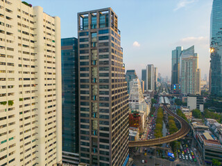 Aerial view city office building with BTS urban train transport sunset sky Silom district