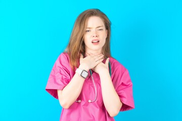 young beautiful red haired doctor woman shouting suffocate because painful strangle. Health problem. Asphyxiate and suicide concept. - obrazy, fototapety, plakaty