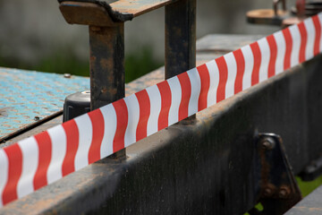 An orange-striped warning tape. Attention danger zone.