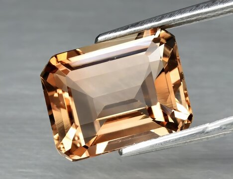 Natural gemstone orange topaz on a gray background. Imperial topaz, champagne topaz