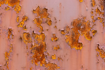 Metal old wall or sheet with rust and corrosion, cracked paint close up