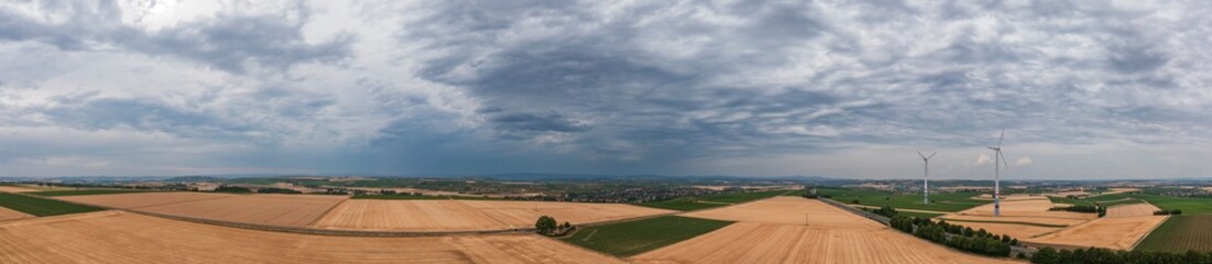 Bird's-eye view of grain fields in Rhineland-Palatinate/Germany and a few wind turbines