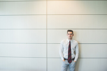 Young millennial businessman posing indoors office  reassuring