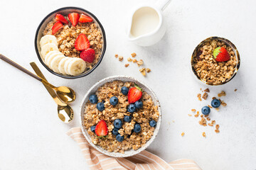 Crunchy oat granola with fresh fruits, berries and oat milk on table. Top view flat lay healthy breakfast food - 638486876