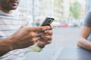 Young man using smart phone outdoor