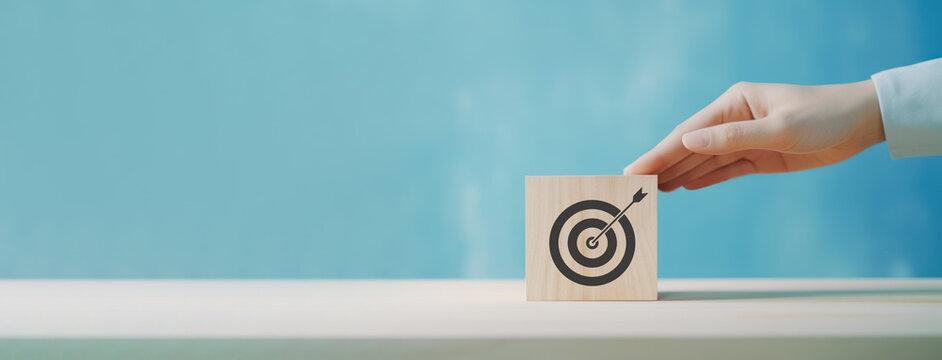 Goal and planning concept, Hand holding wooden block with target aiming dart board, Business achievement objective goal and project progress growth value processing marketing financial, Reach target