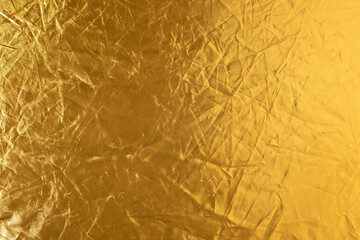 shiny gold color with creases texture abstract background