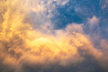 voluminous turbulent colorful cumulus clouds sky at sunset