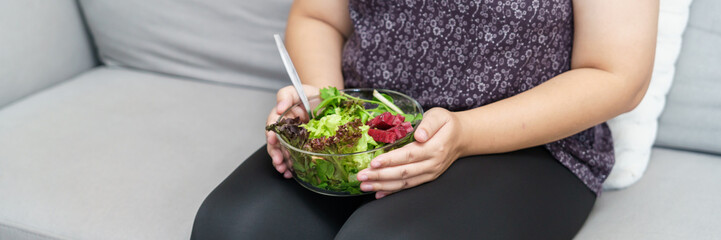 Asian Overweight woman dieting Weight loss eating fresh fresh homemade salad healthy eating concept Obese Woman with weight diet lifestyle.